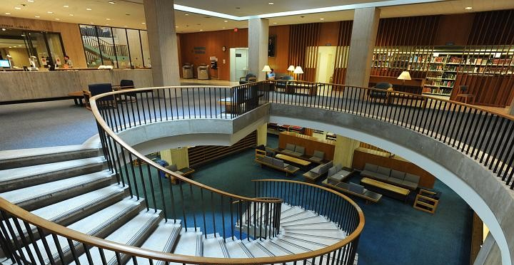 A shot of Lehman Library with a winding staircase going down to the lower floor