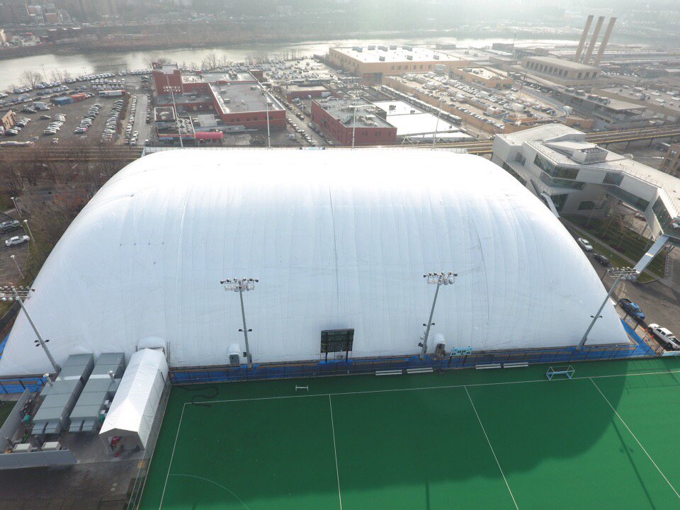 A white, inflated, vinyl dome covering a soccer field 