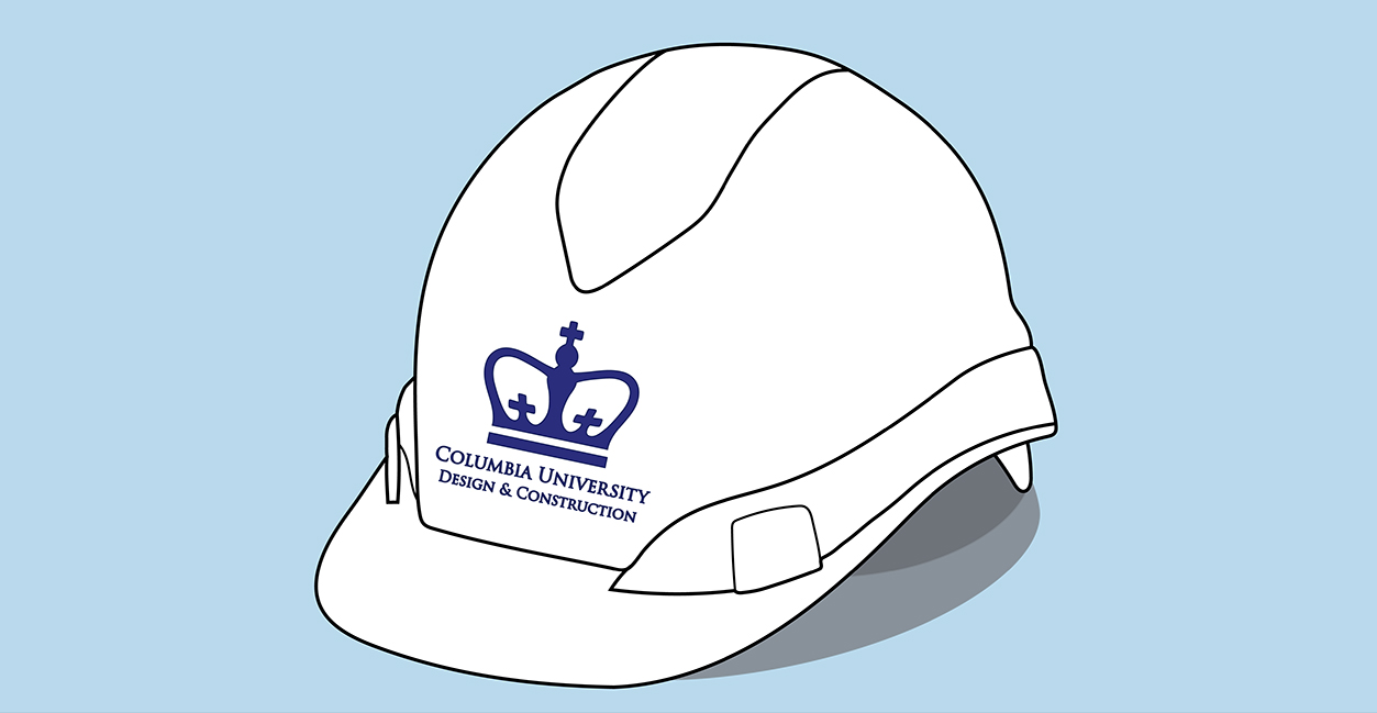 White hard hat with Columbia University Design and Construction logo on the front above the brim.