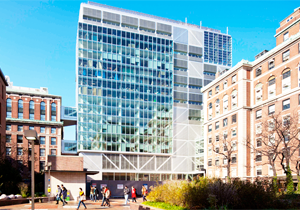 Northwest Corner Building exterior, glass and steel structure, overlooking small courtyard with students