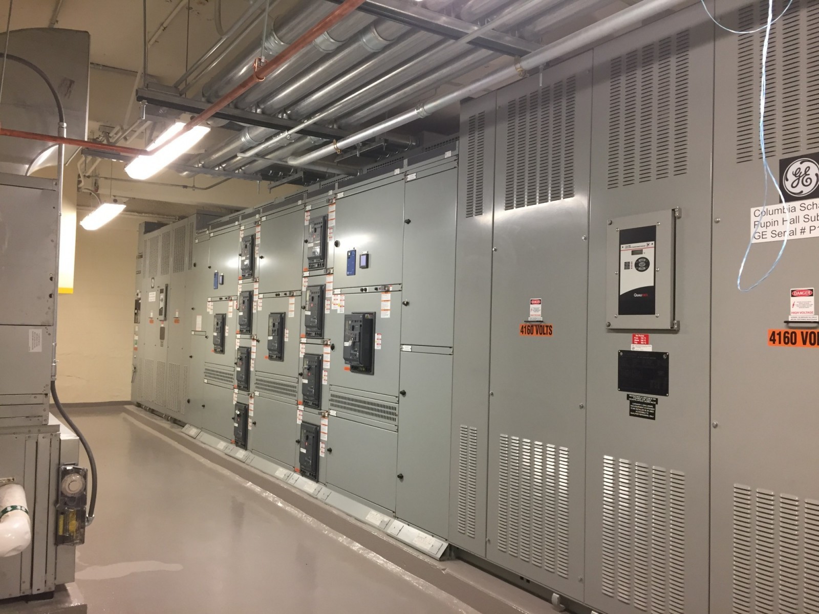 Basement-level metal mechanical equipment and electrical boxes.