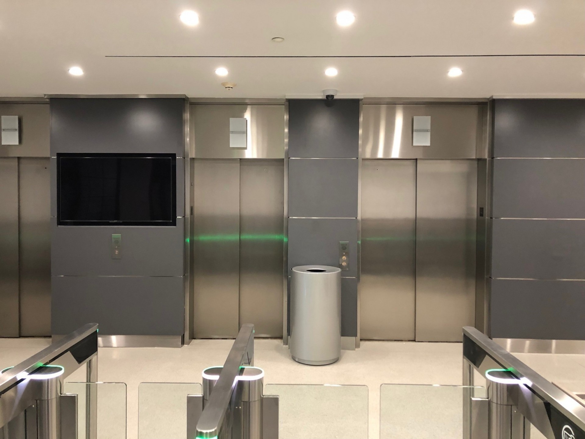 A bank of elevators behind turnstiles