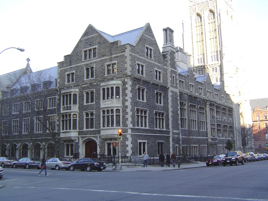 A 5-story, grey stone Gothic building at the corner of two streets.