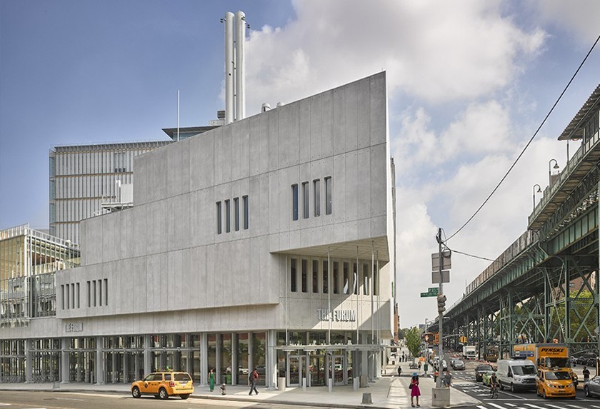 The forum exterior, a wedge-shaped concrete and glass structure