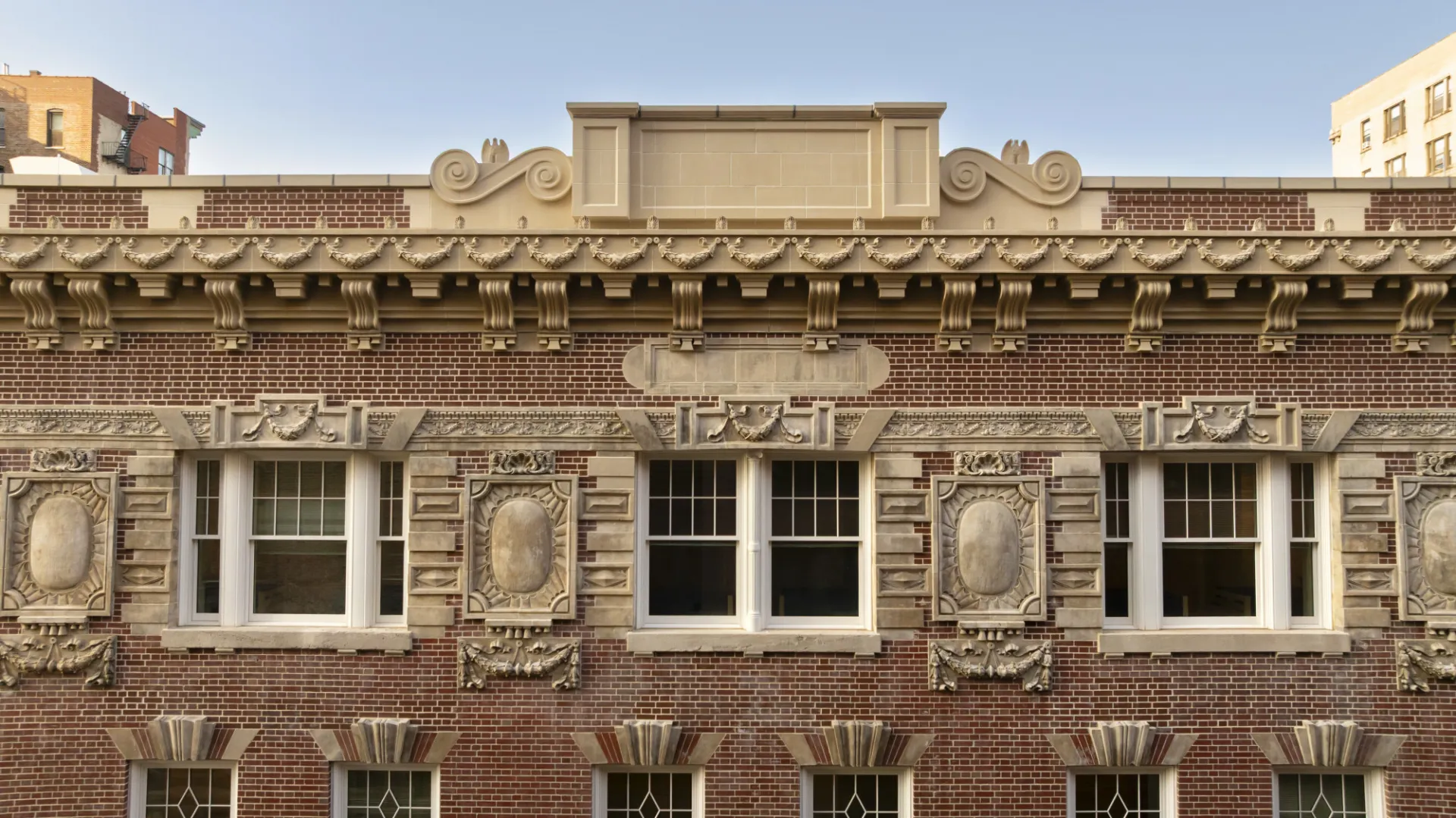 A closeup of the cornice at the top of the building of 611 W. 112th Street. 