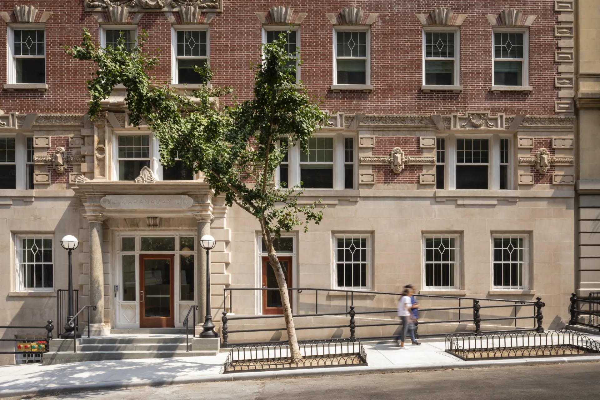 The limestone and brick exterior of 611 W. 112th Street, a landmarked building in the Morningside Heights Historic District.