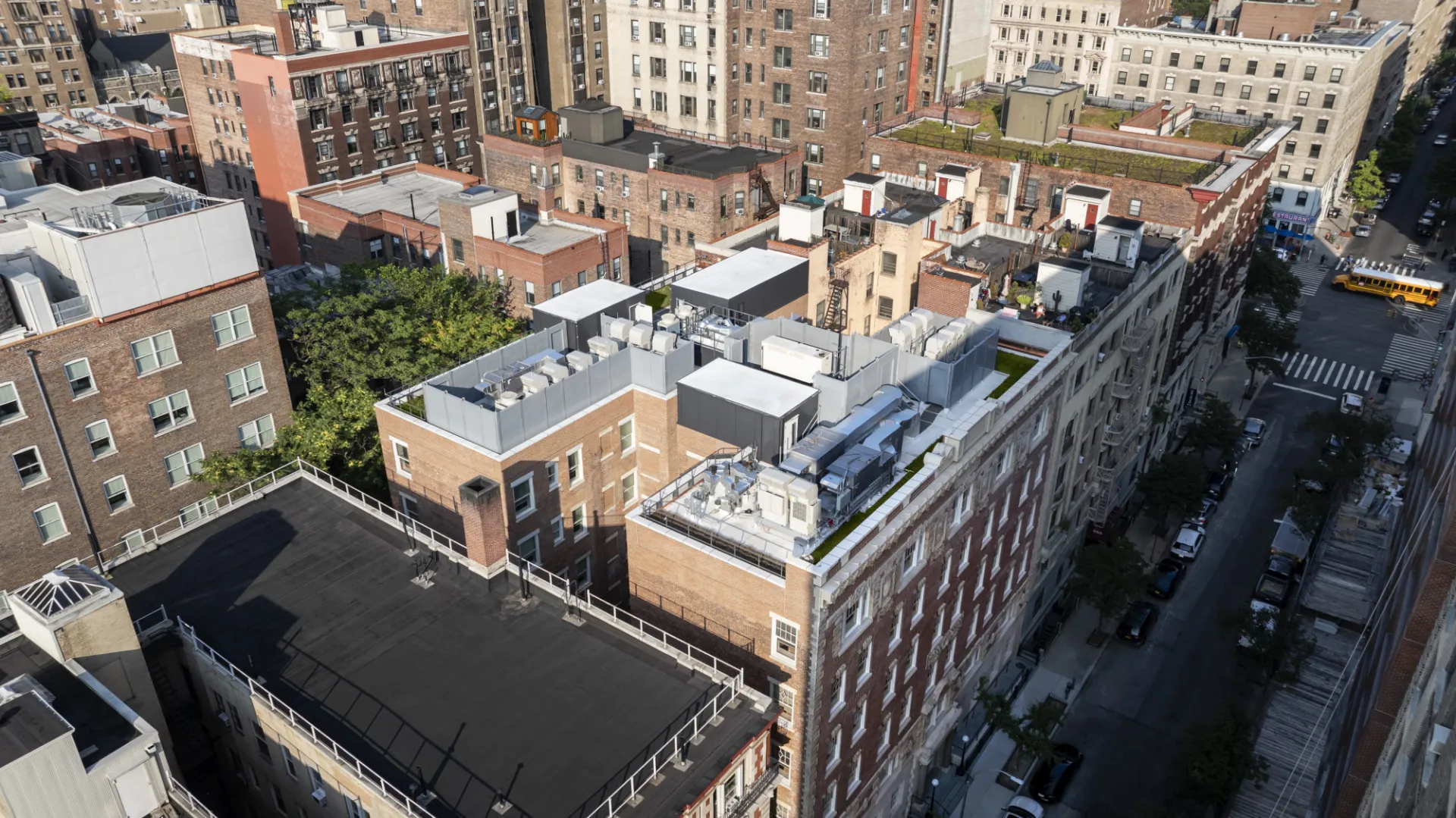 A shot of the roof of the building with all of the building equipment on it.