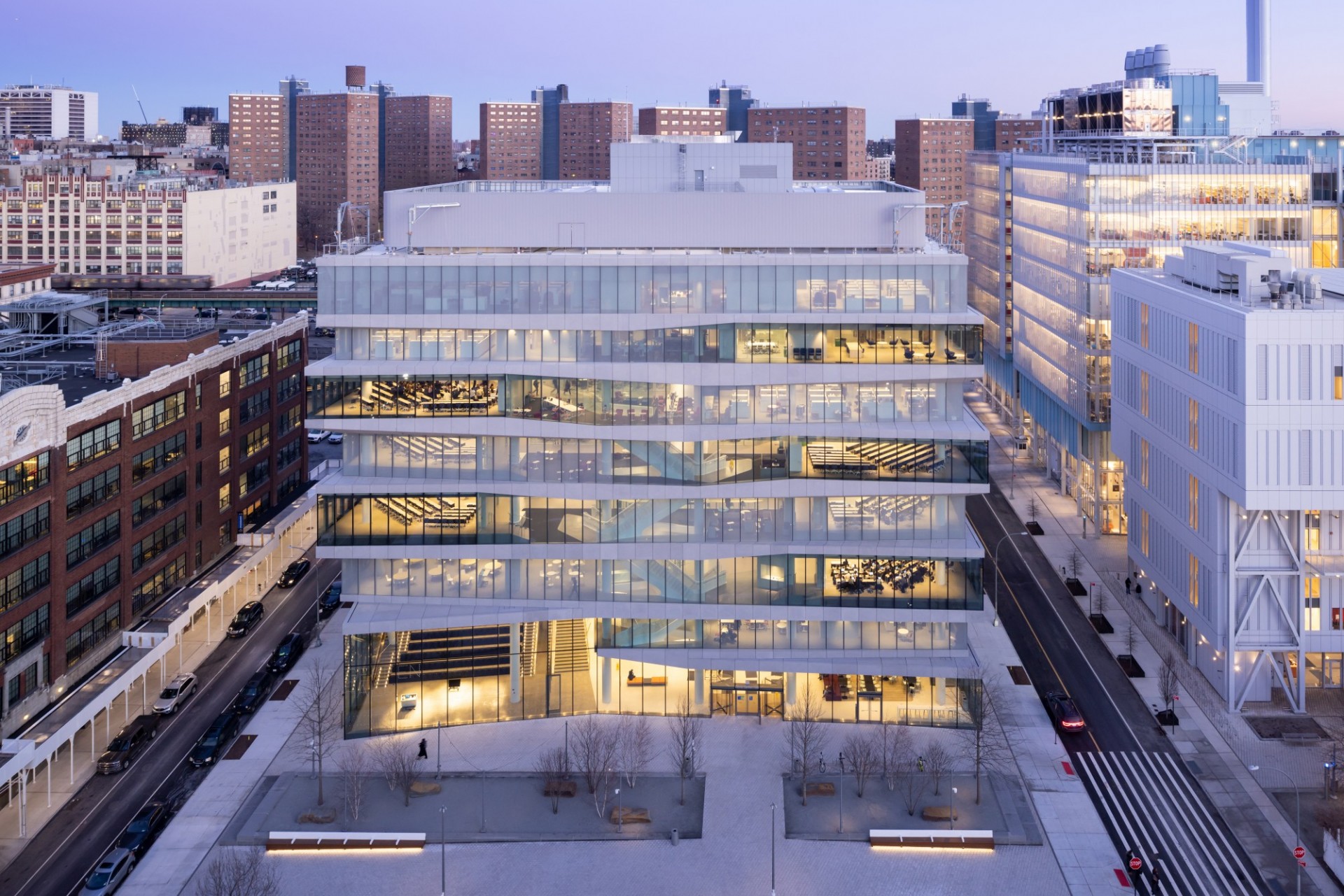 Columbia Business School received an Honor Award from the American Institute of Architects (AIA) New York as part of their 2023 Design Awards program. (Photo: Iwan Baan) David Geffen Hall during dusk, surrounded by the Studebaker Building, Lenfest Center for the Arts, and Jerome L. Greene Science Center.