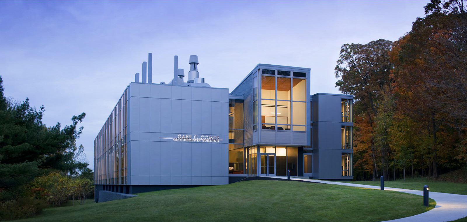 The Gary C. Comer Building, a concrete and glass structure, at dusk.