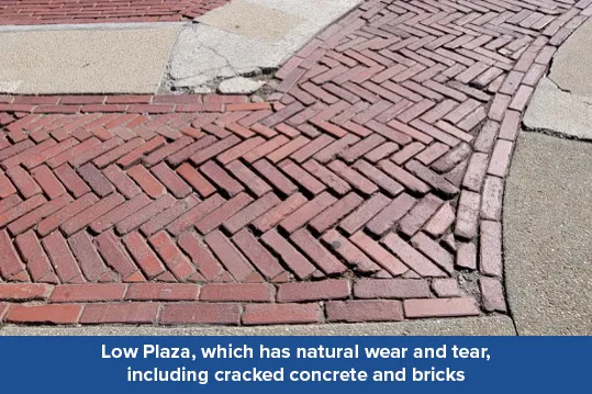 A close up view of cracked bricks and concrete in Low Plaza. 